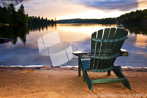 Image of Wooden chair at sunset on beach