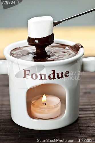 Image of Marshmallow dipped in chocolate fondue