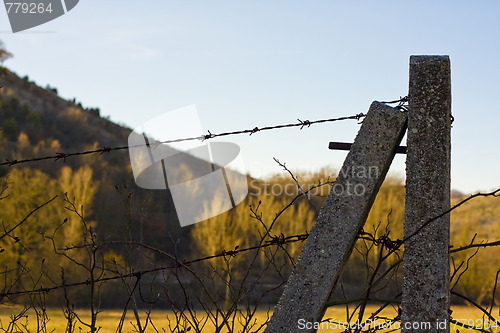 Image of fence with barbed wire in forest mountains