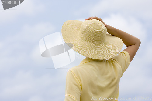 Image of Woman with hat in front of sky