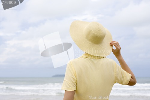 Image of Woman with hat on a beach