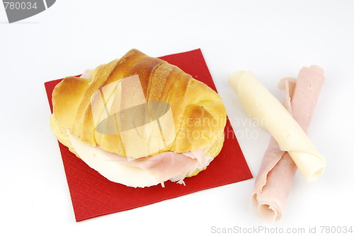 Image of Cheese and ham croissant on a red napkin