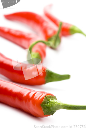 Image of five red chili peppers