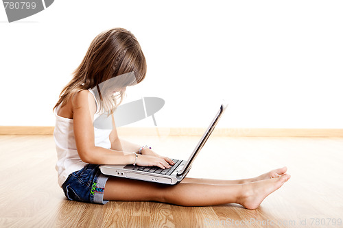 Image of Child playing with a laptop