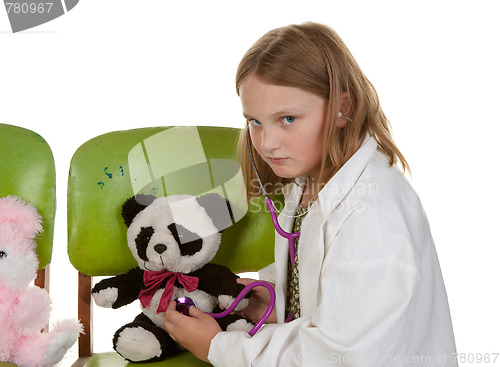 Image of girl playing doctor with her toys