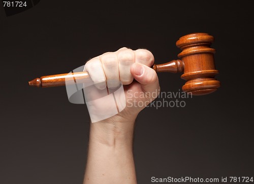 Image of Male Fist Holding Wooden Gavel