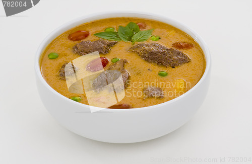Image of red curry in a white bowl