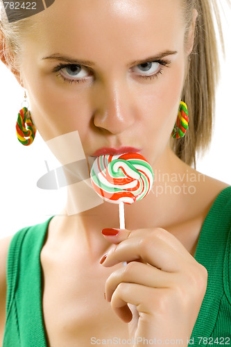 Image of Glamorous young woman licking lollypop