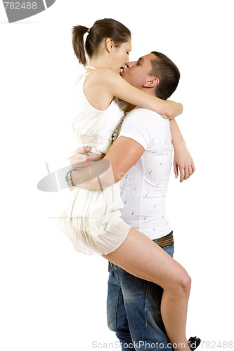 Image of young man holding his girlfriend in the air