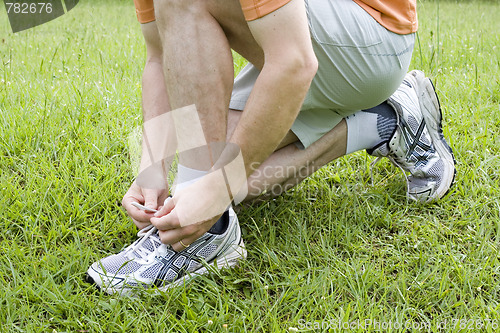 Image of Jogger tying his shoes