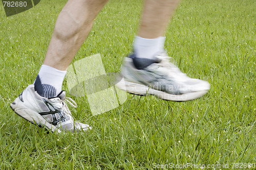 Image of Running feet in green grass