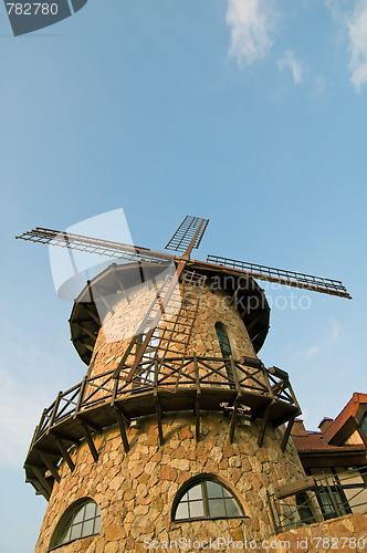 Image of stylized windmill at blue sky