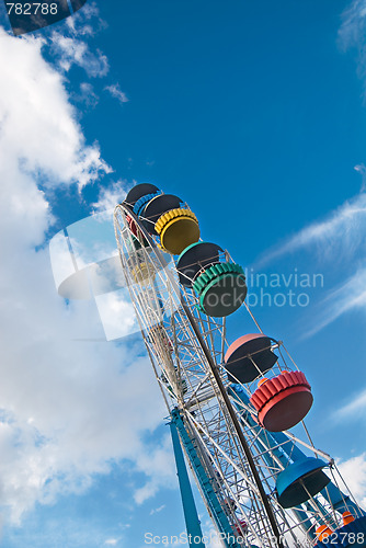 Image of Ferris wheel over dreamy cloudy sky