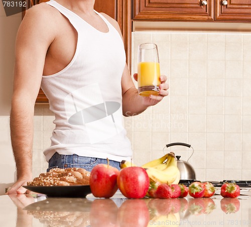 Image of Young Man Holding Glass of Orange Juice