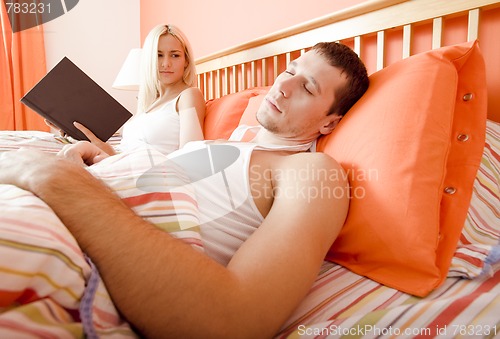 Image of Couple Relaxing in Bed