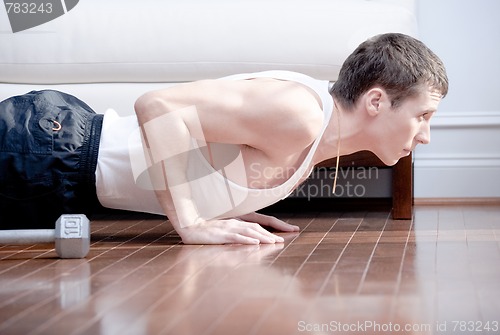 Image of Man Doing Push-ups in Living Room