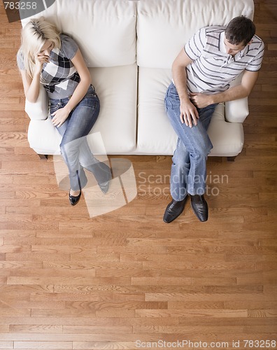 Image of Young Couple Sitting on Love Seat