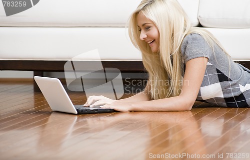 Image of Woman Reclining on Floor With Laptop