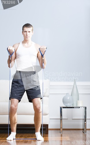 Image of Man Using Resistance Bands in Living Room