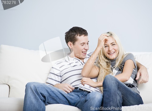 Image of Affectionate Couple Laughing and Relaxing on Couch