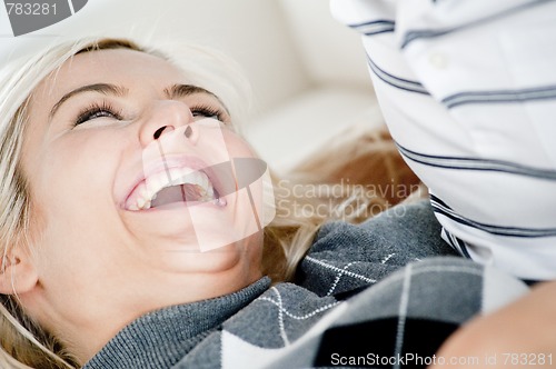 Image of Laughing Woman By Man's Chest