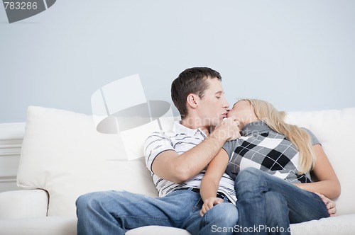 Image of Couple Kissing on Couch
