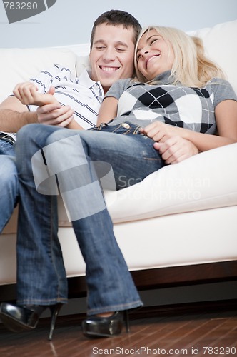 Image of Affectionate Couple Laughing and Relaxing on Couch