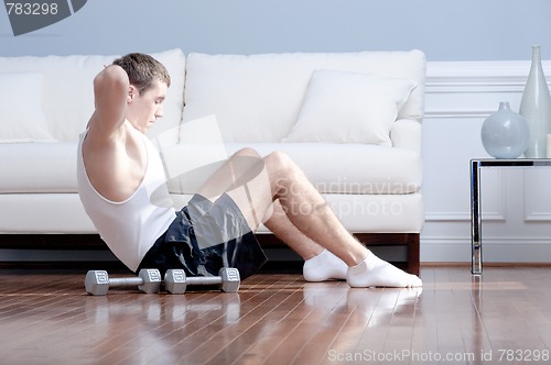 Image of Man Doing Sit-ups in Living Room