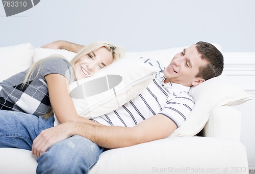 Image of Young Couple Reclining on Sofa