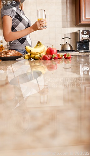 Image of Young Woman Holding Glass of Orange Juice