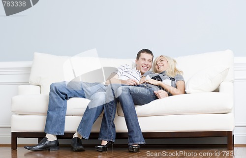 Image of Affectionate Couple Laughing and Relaxing on Couch