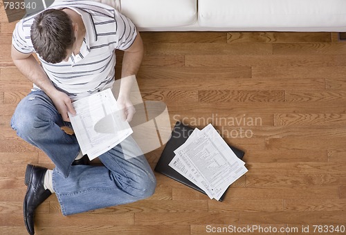 Image of Young Man Doing Taxes