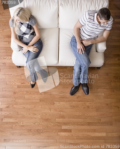 Image of Young Couple Sitting on Love Seat