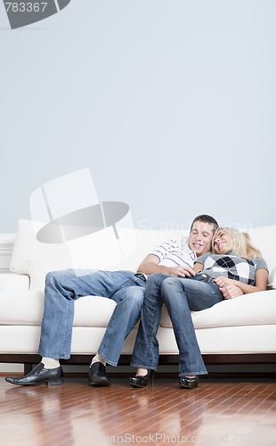 Image of Affectionate Couple Laughing and Relaxing on Couch