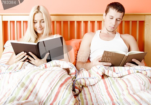 Image of Couple Reading in Bed