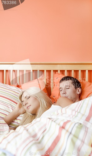 Image of Young Couple Sleeping in Bed