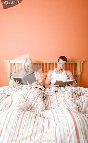 Image of Couple Reading in Bed