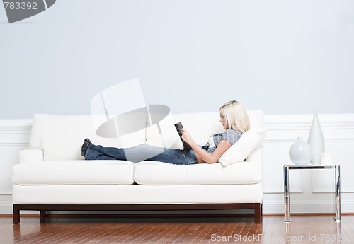 Image of Woman Reclining on Couch With Book