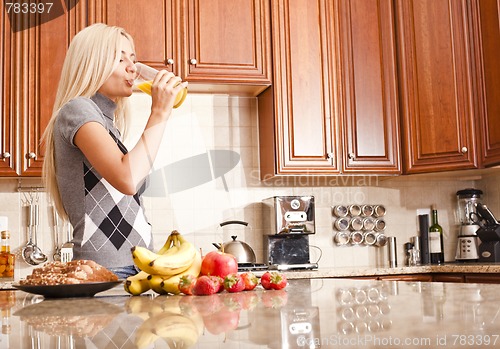 Image of Young Woman Drinking Glass of Orange Juice