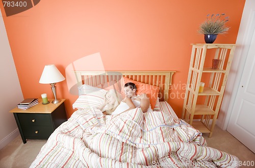 Image of Young Couple Sleeping in Bed