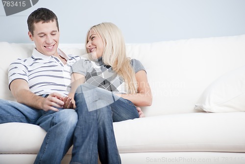 Image of Affectionate Couple Laughing and Relaxing on Couch
