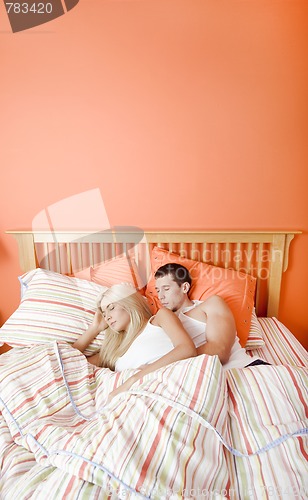 Image of Young Couple Sleeping in Bed