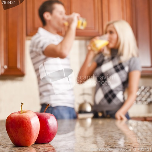 Image of Young Couple Drinking Glass of Orange Juice