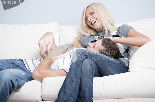 Image of Affectionate Couple Laughing and Relaxing on Couch