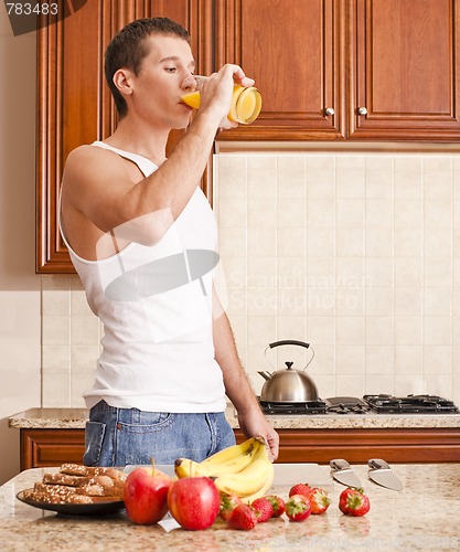 Image of Young Man Drinking Orange Juice