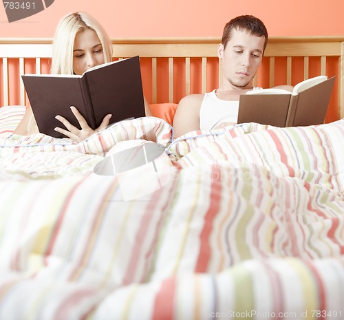 Image of Couple Reading in Bed