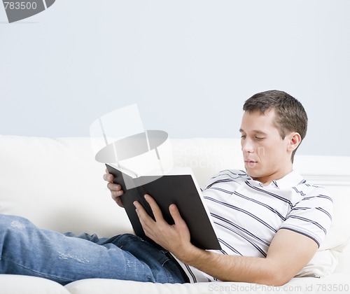 Image of Man Reading on Couch