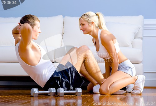 Image of Couple Exercising on Living Room Floor