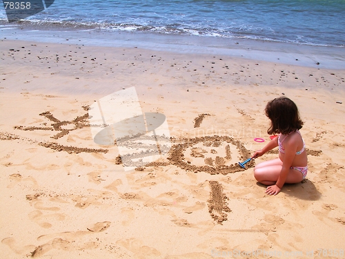 Image of child drawing at the beach