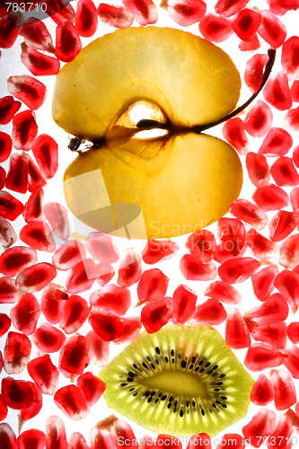 Image of beautiful pomegranate grains, kiwi and tasty apple 